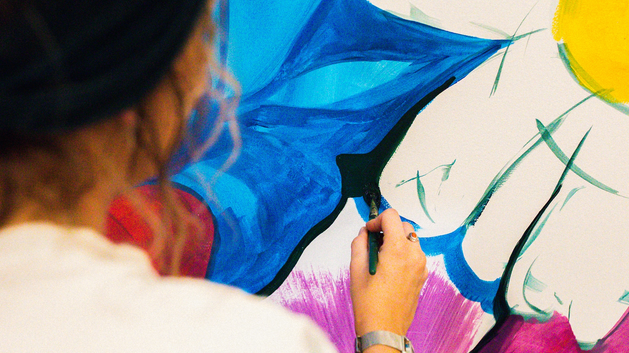 a woman painting a flower