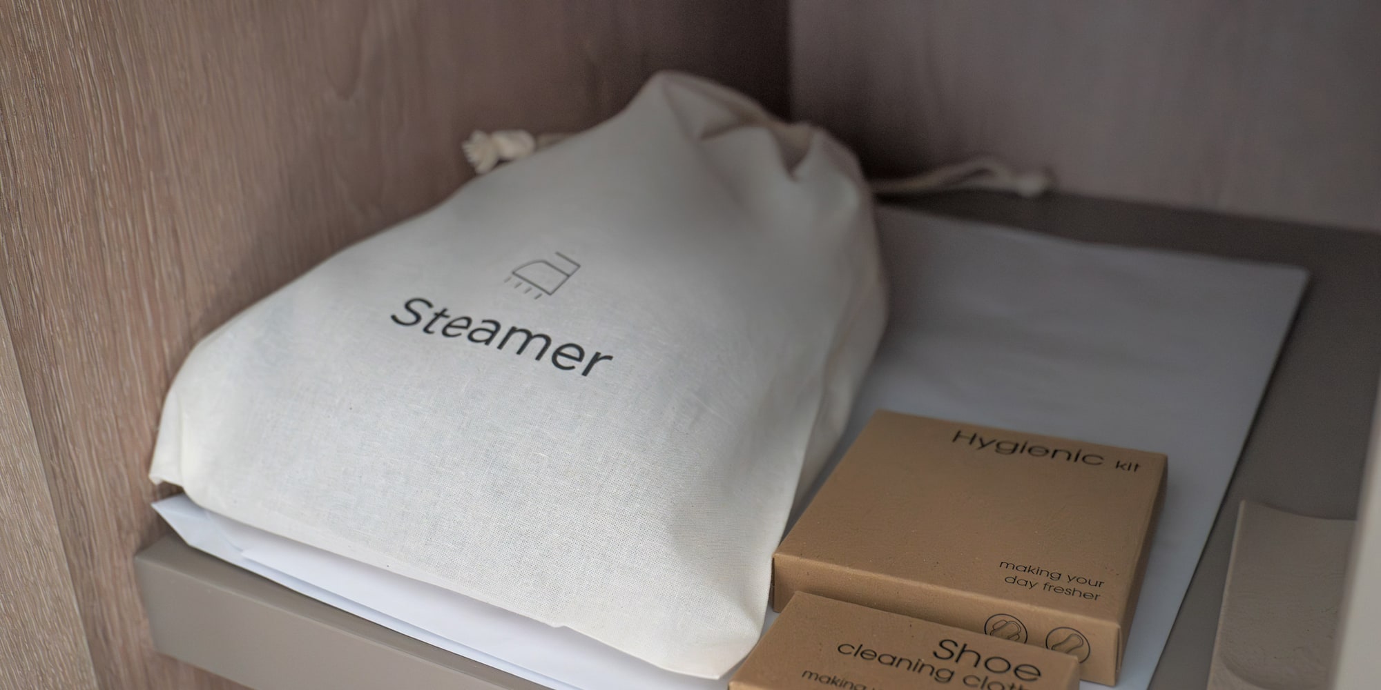 a white bag and brown boxes on a shelf