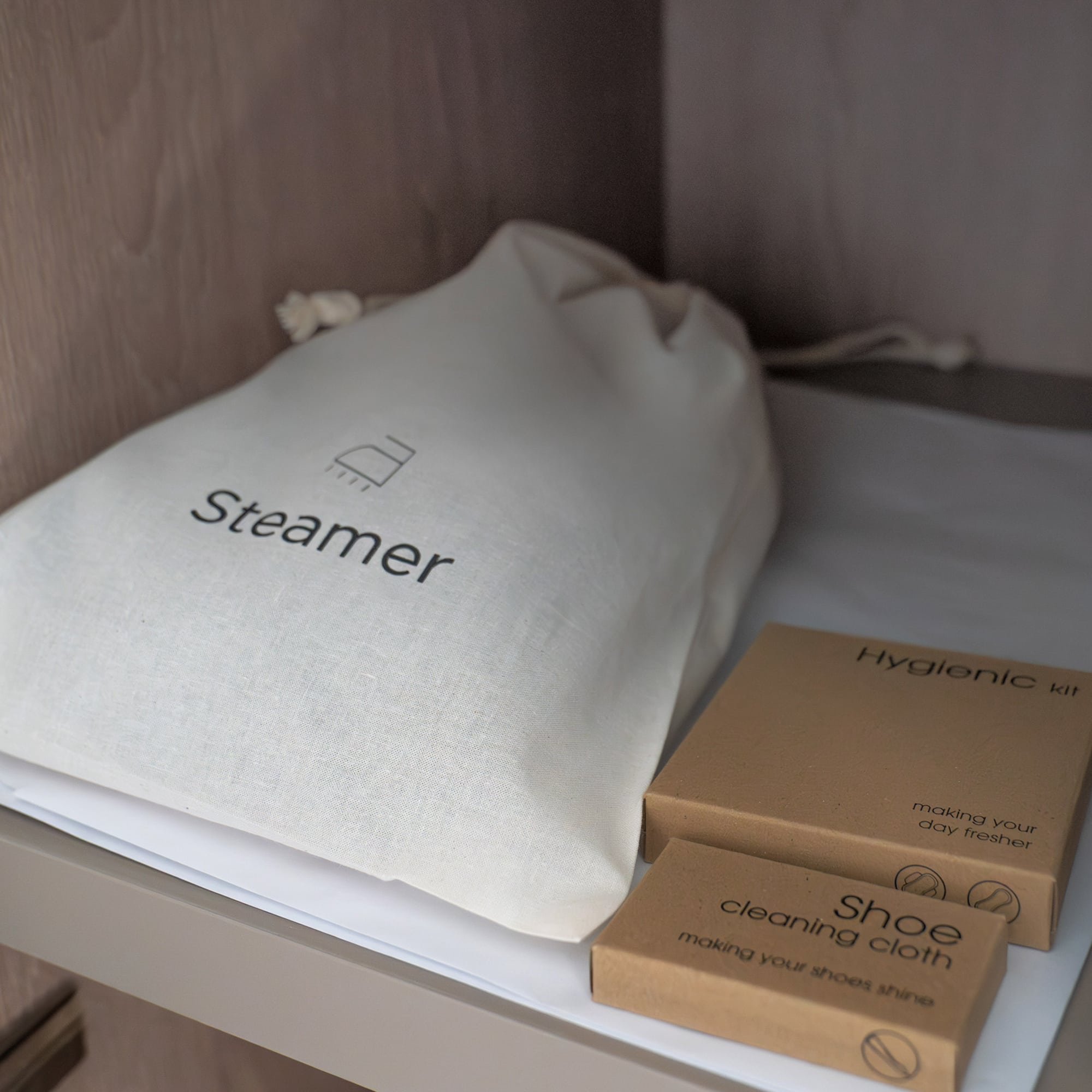 a white bag and brown boxes on a shelf