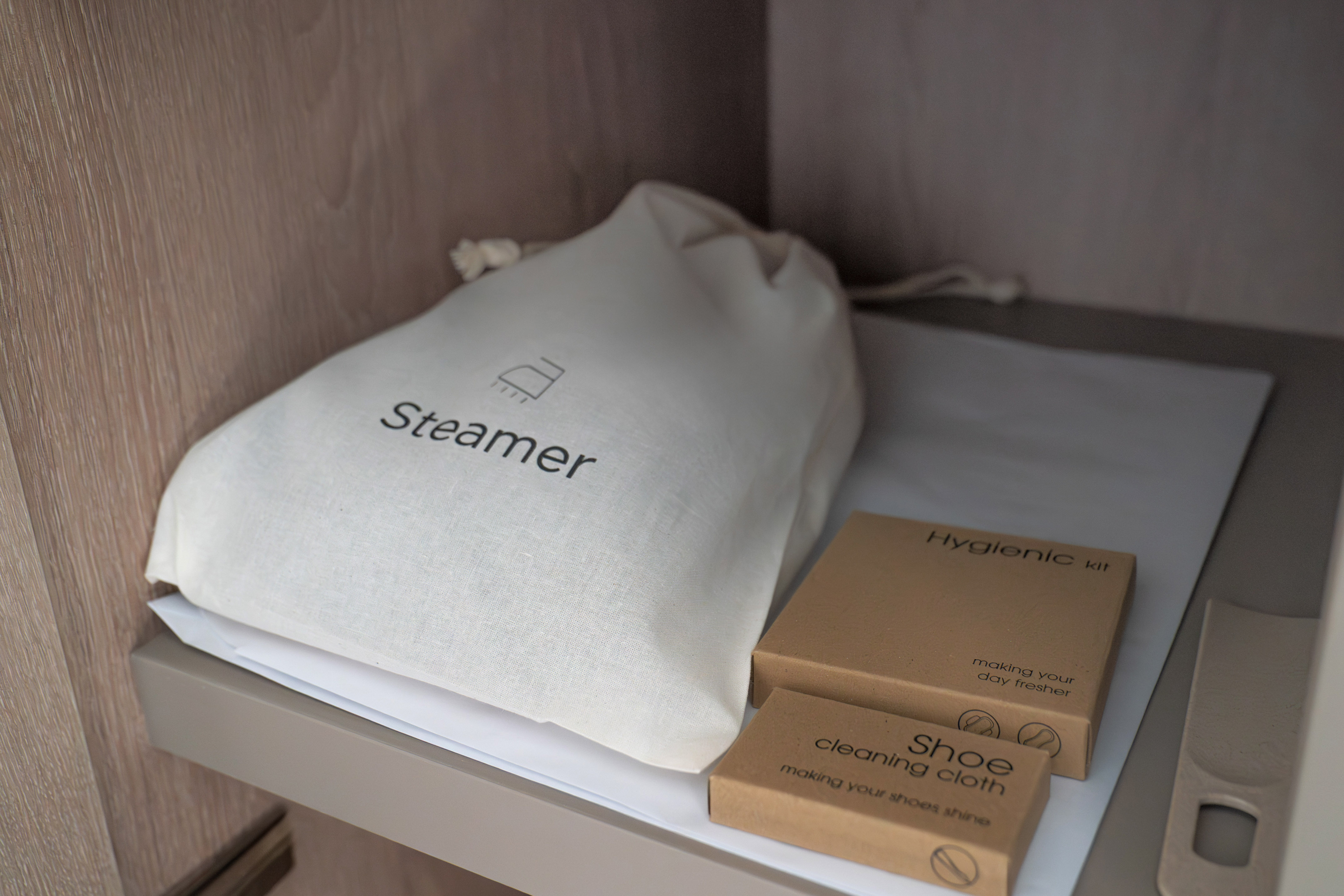 Hotel room amenities: steamer bag, hygienic kit, shoe cleaning kit.