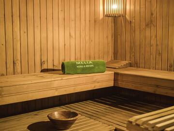 a wooden sauna with a bowl and a towel