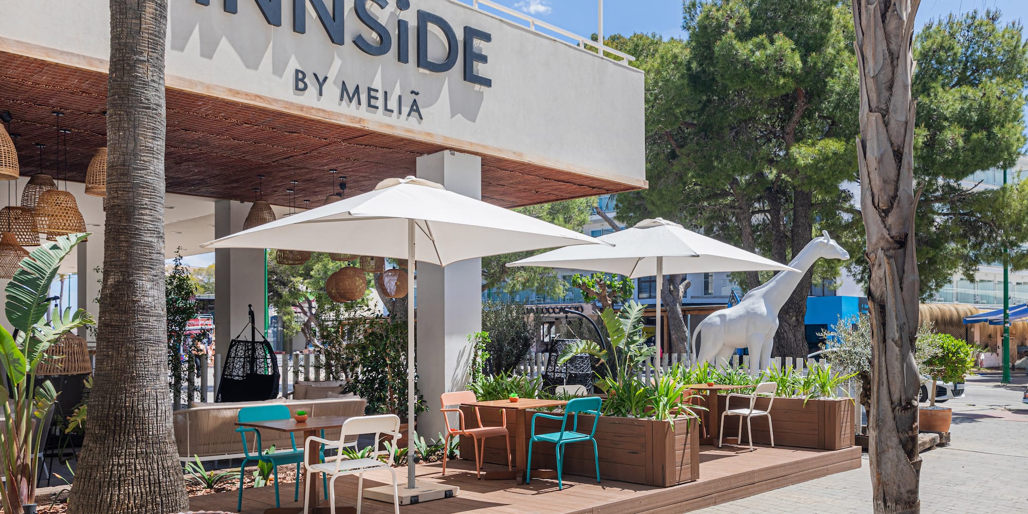 a building with a sign and tables and chairs