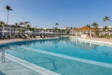 a swimming pool with lounge chairs and a building