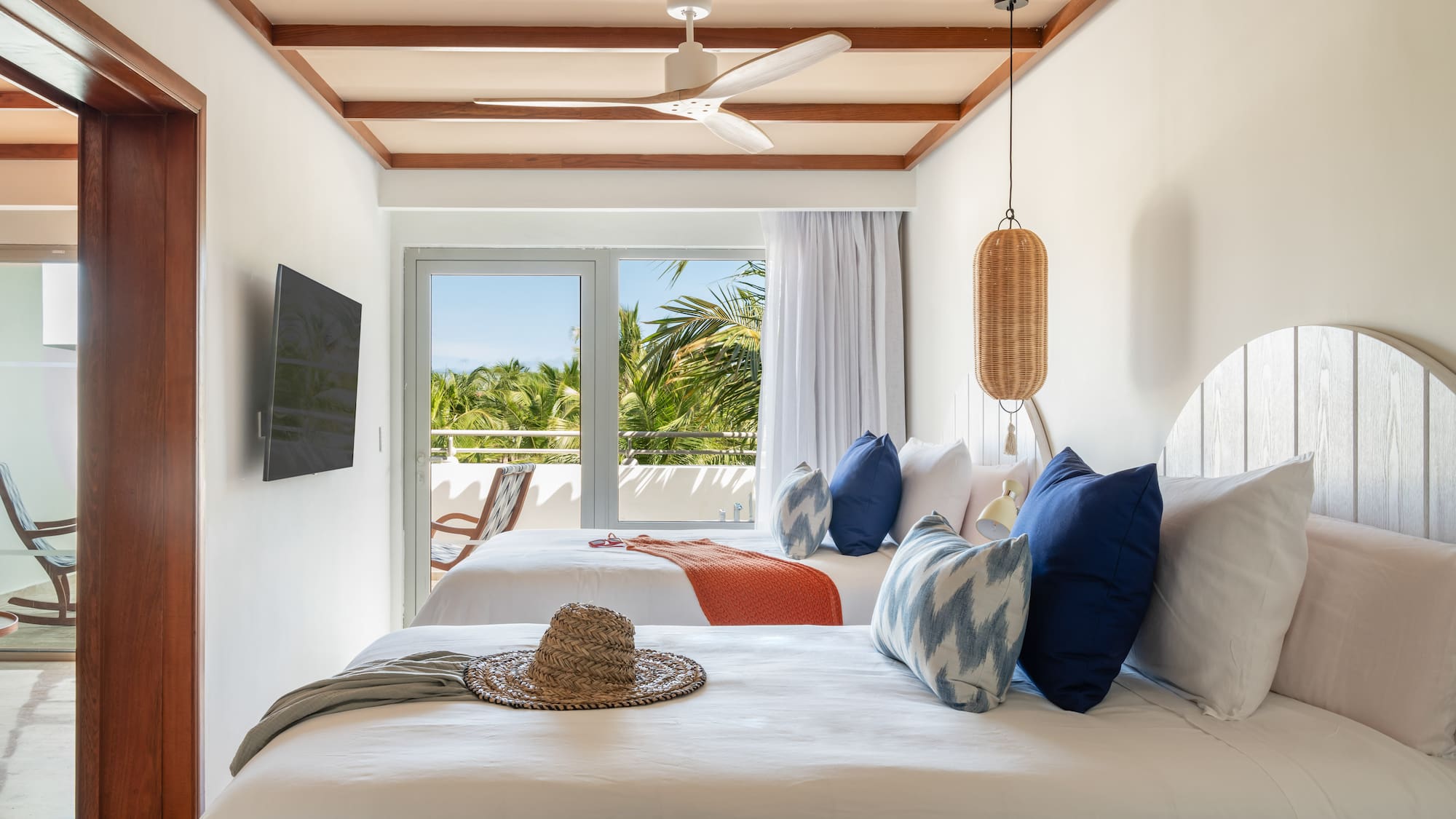 a room with two beds and a fan