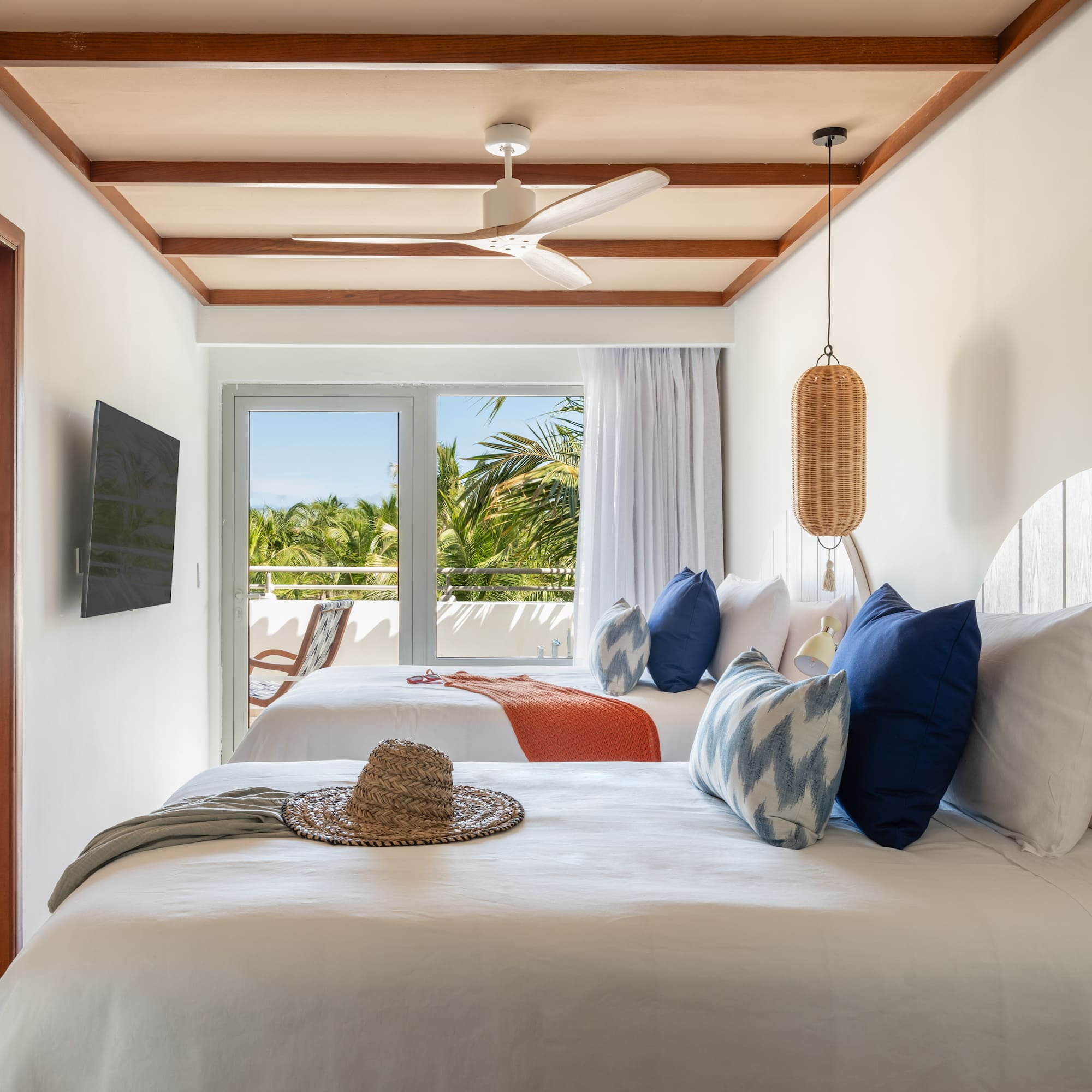 a room with two beds and a fan