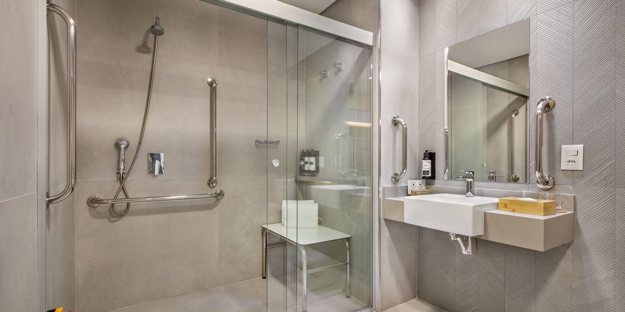 a bathroom with a glass shower door and sink