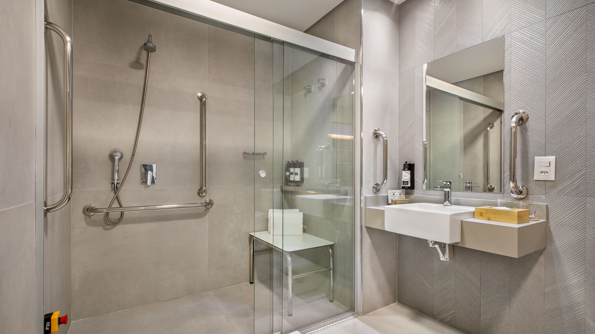 a bathroom with a glass shower door and sink