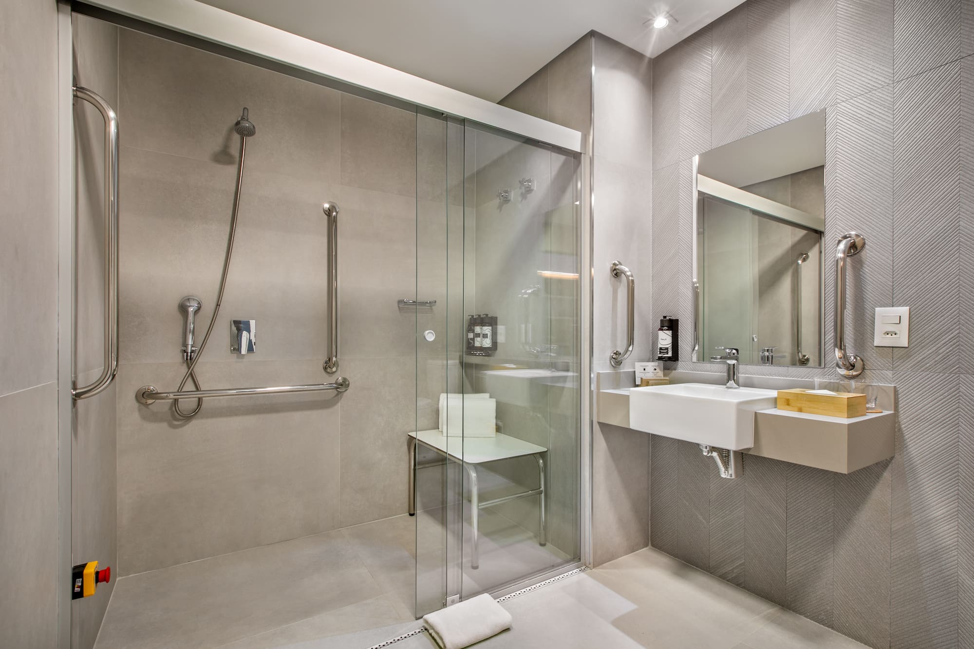 a bathroom with a glass shower door and sink