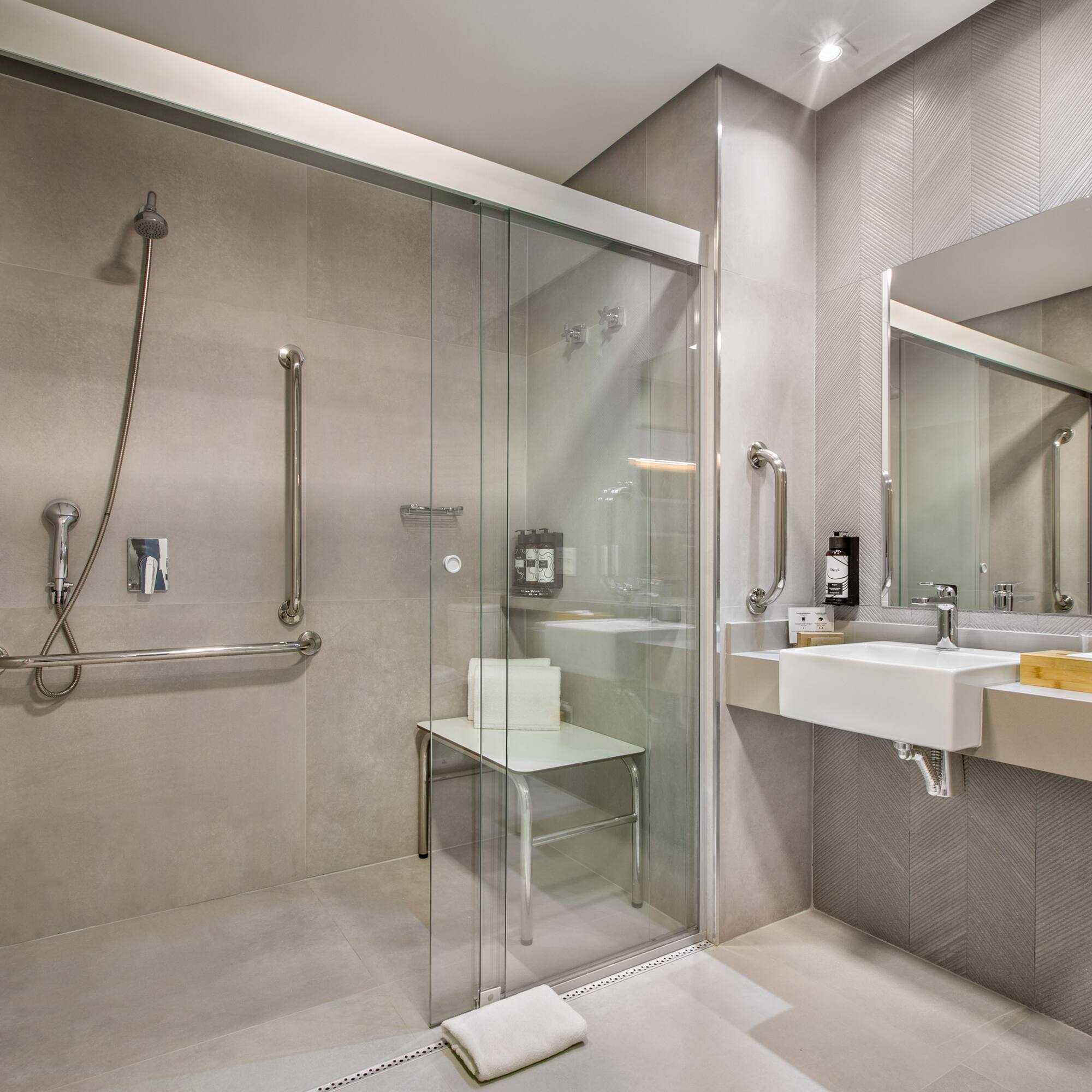 a bathroom with a glass shower door and sink