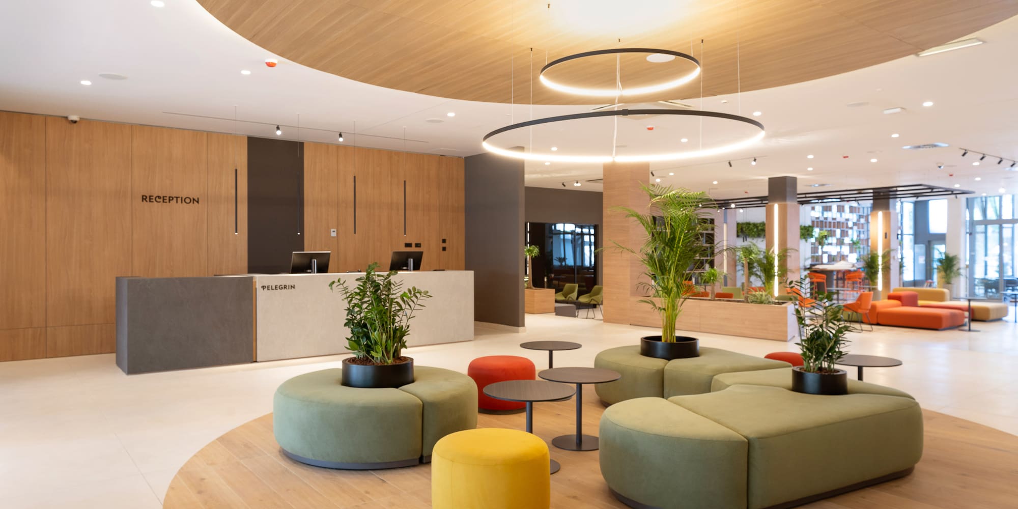 a lobby with a large round table and chairs