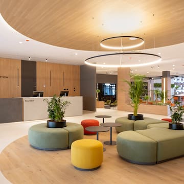 a lobby with a large round table and chairs