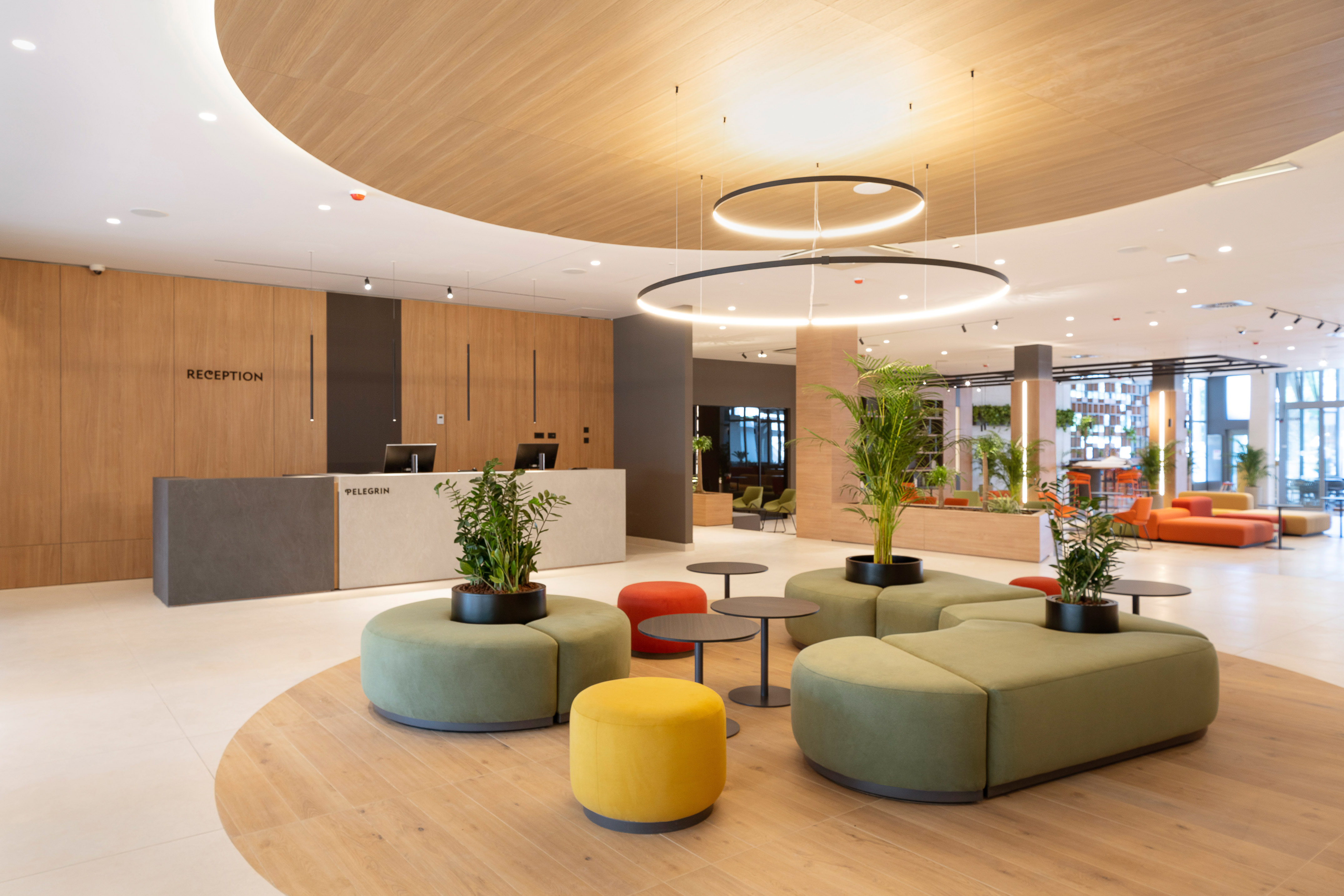 a lobby with a large round table and chairs