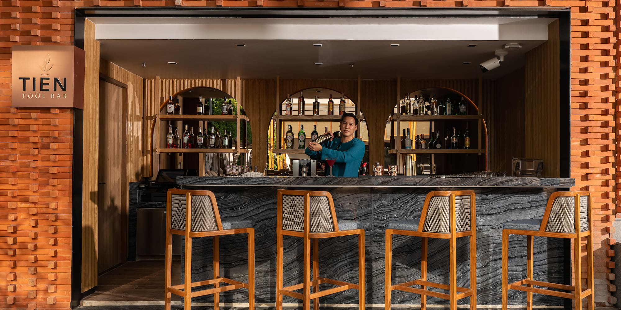 a man standing behind a bar