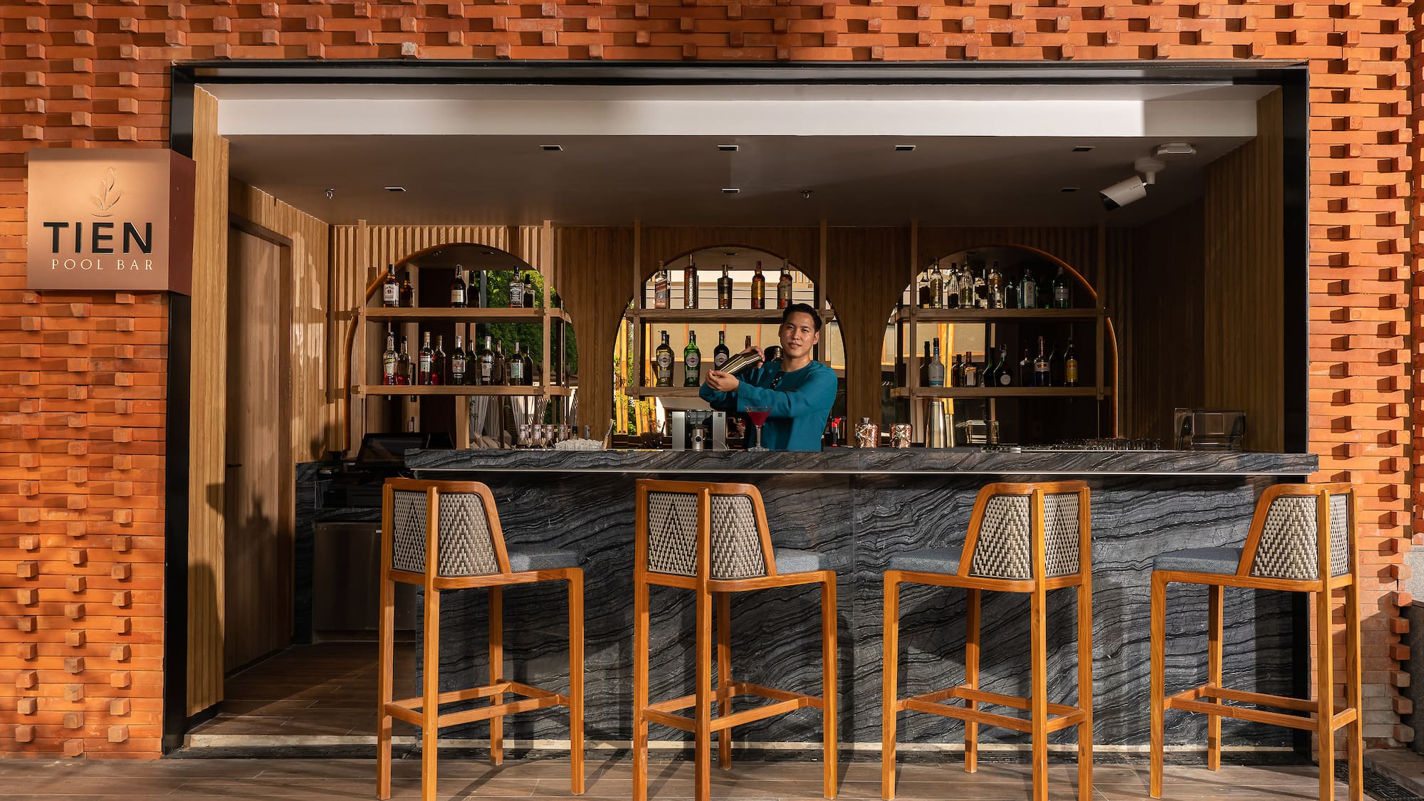 a man standing behind a bar
