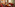 Cozy hotel lounge with red carpet, leather seating, wood tables, warm lighting.