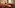 Cozy hotel lounge with red carpet, leather seating, wood tables, warm lighting.