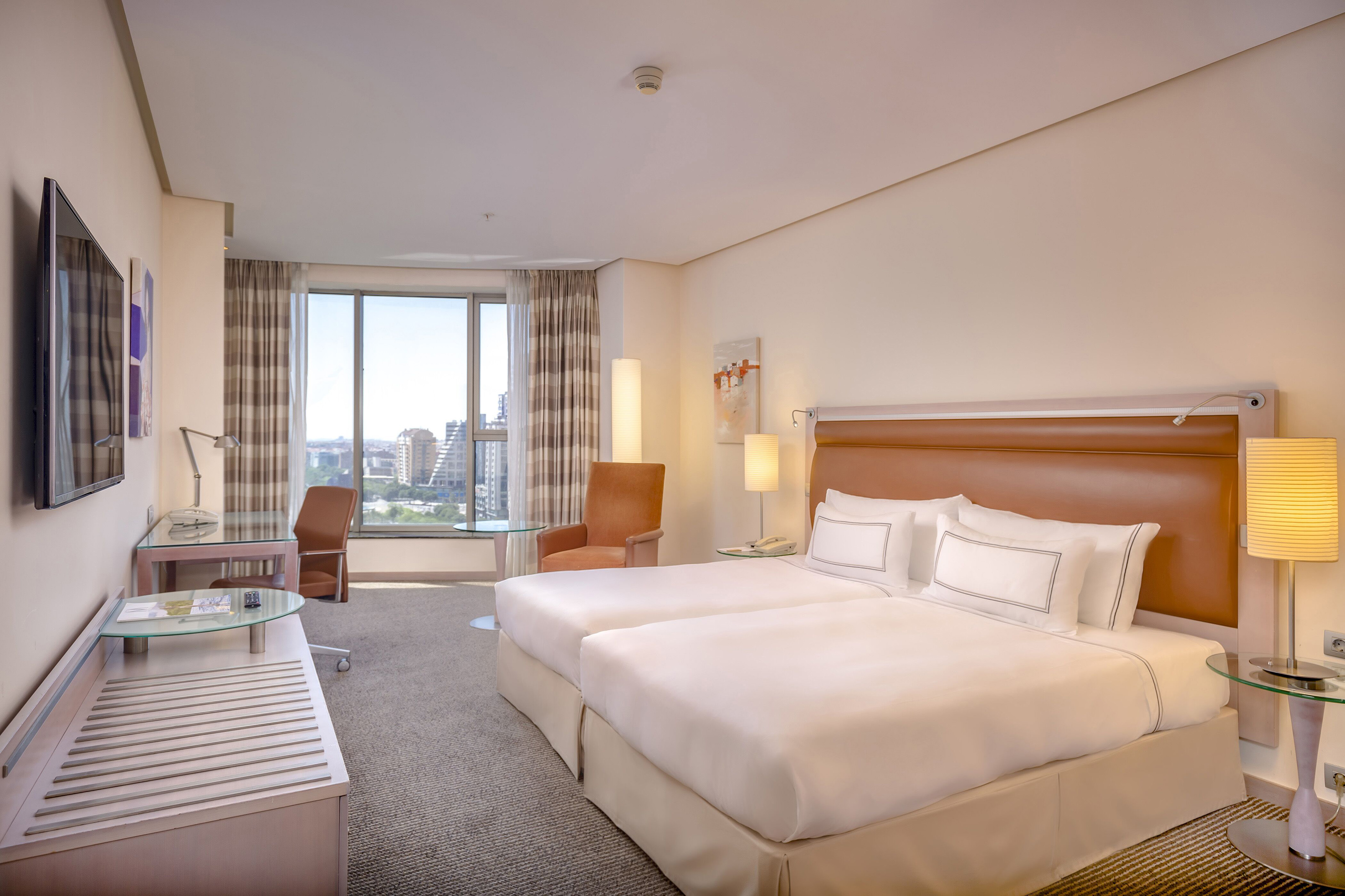 a hotel room with a bed and a table