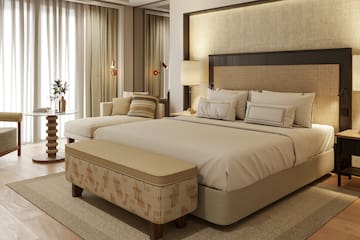 a bedroom with a bed and a chair