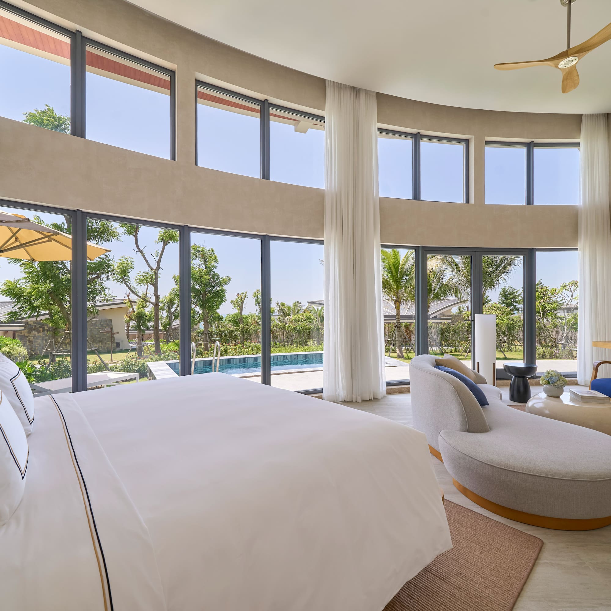 Modern luxury bedroom with private pool, garden view, and large windows.