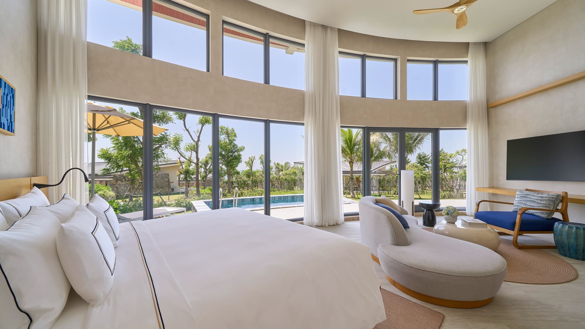 Modern luxury bedroom with private pool, garden view, and large windows.