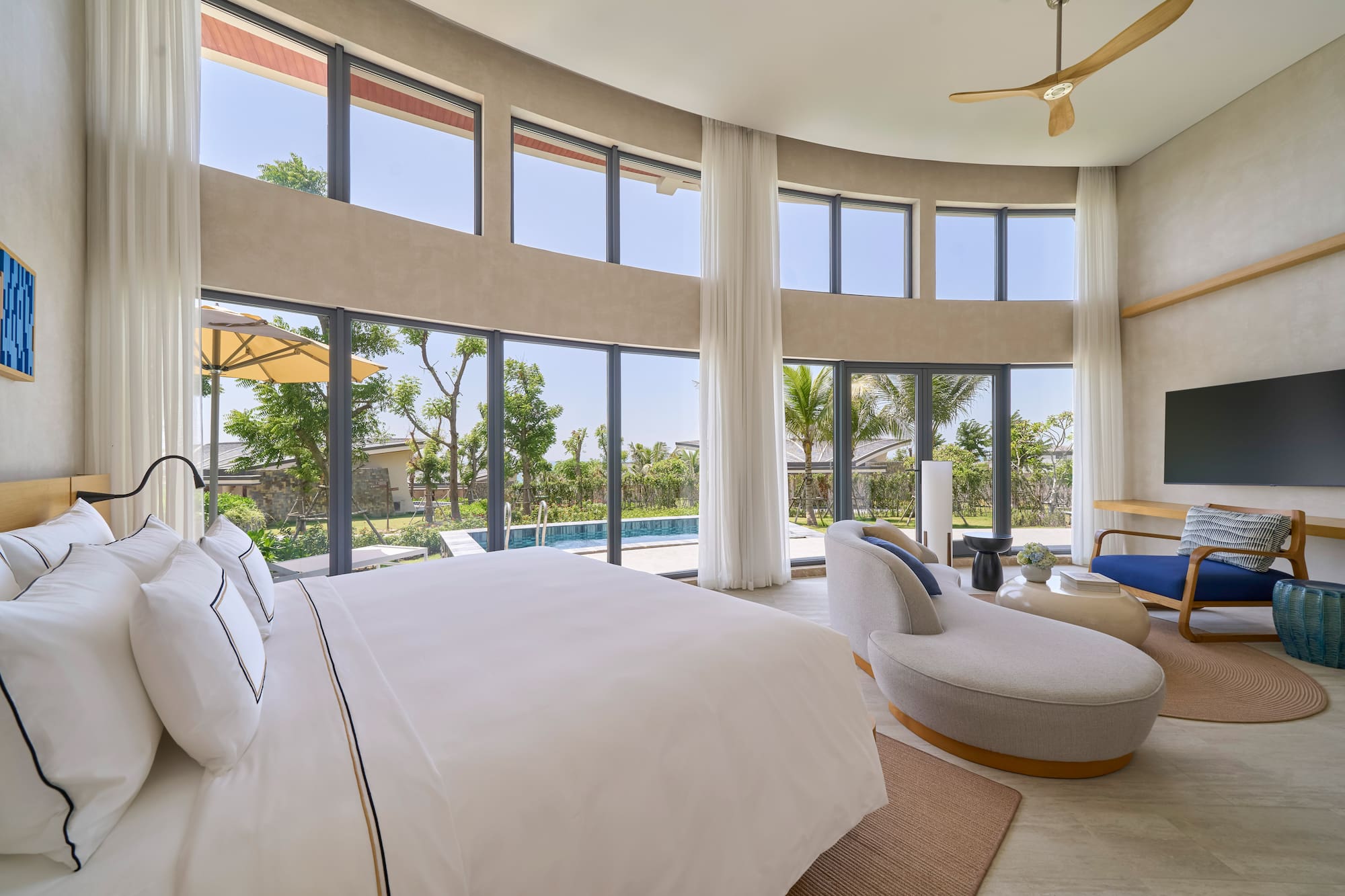 Modern luxury bedroom with private pool, garden view, and large windows.