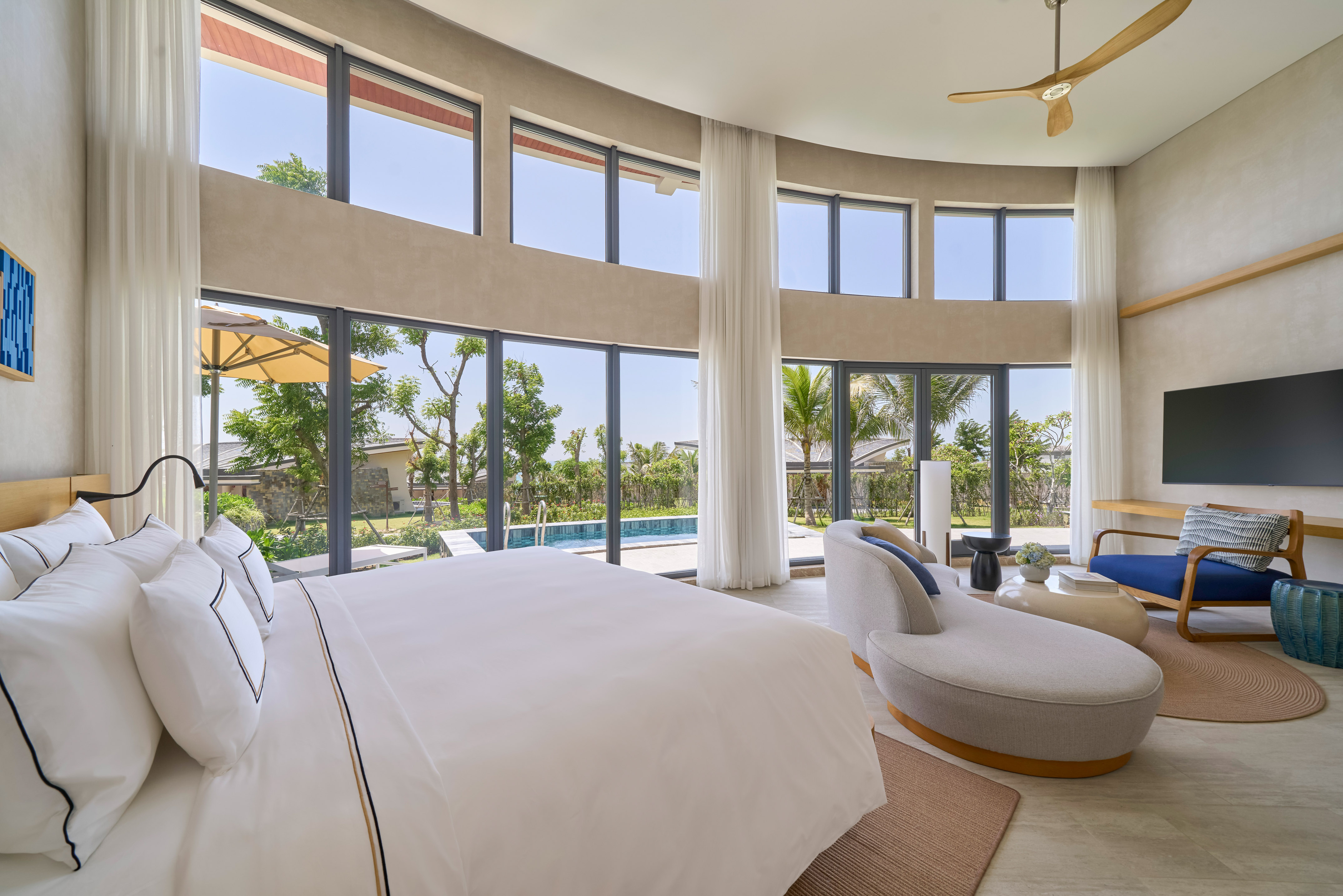Modern luxury bedroom with private pool, garden view, and large windows.