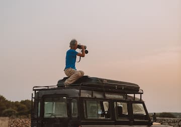 a man taking a picture of a vehicle