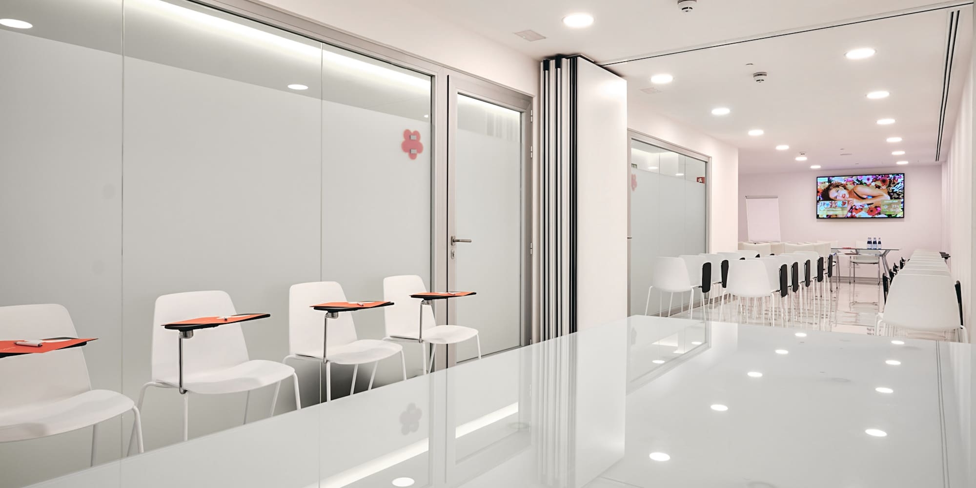 a room with white walls and white chairs