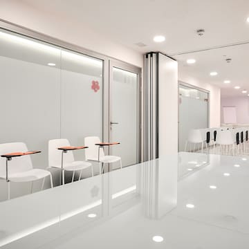 a room with white walls and white chairs