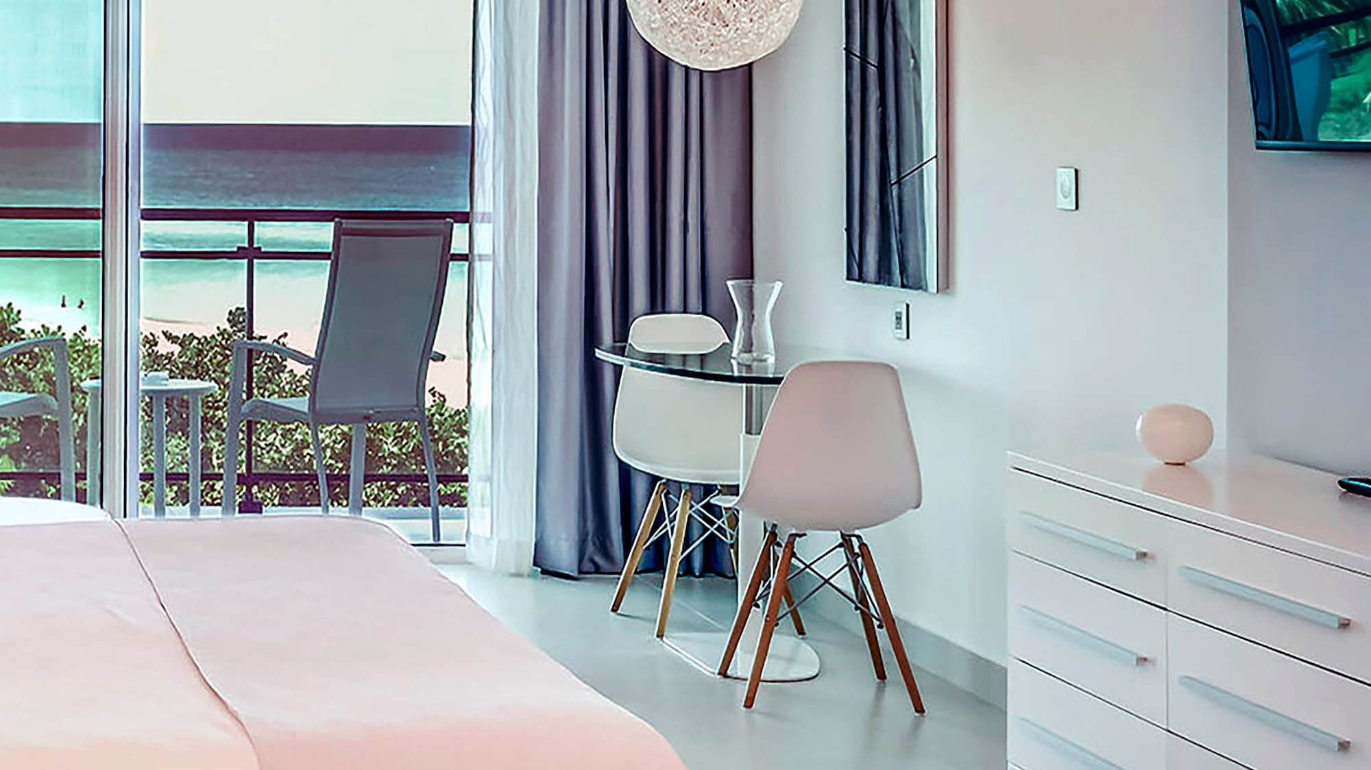 a bedroom with a bed and a desk and chairs