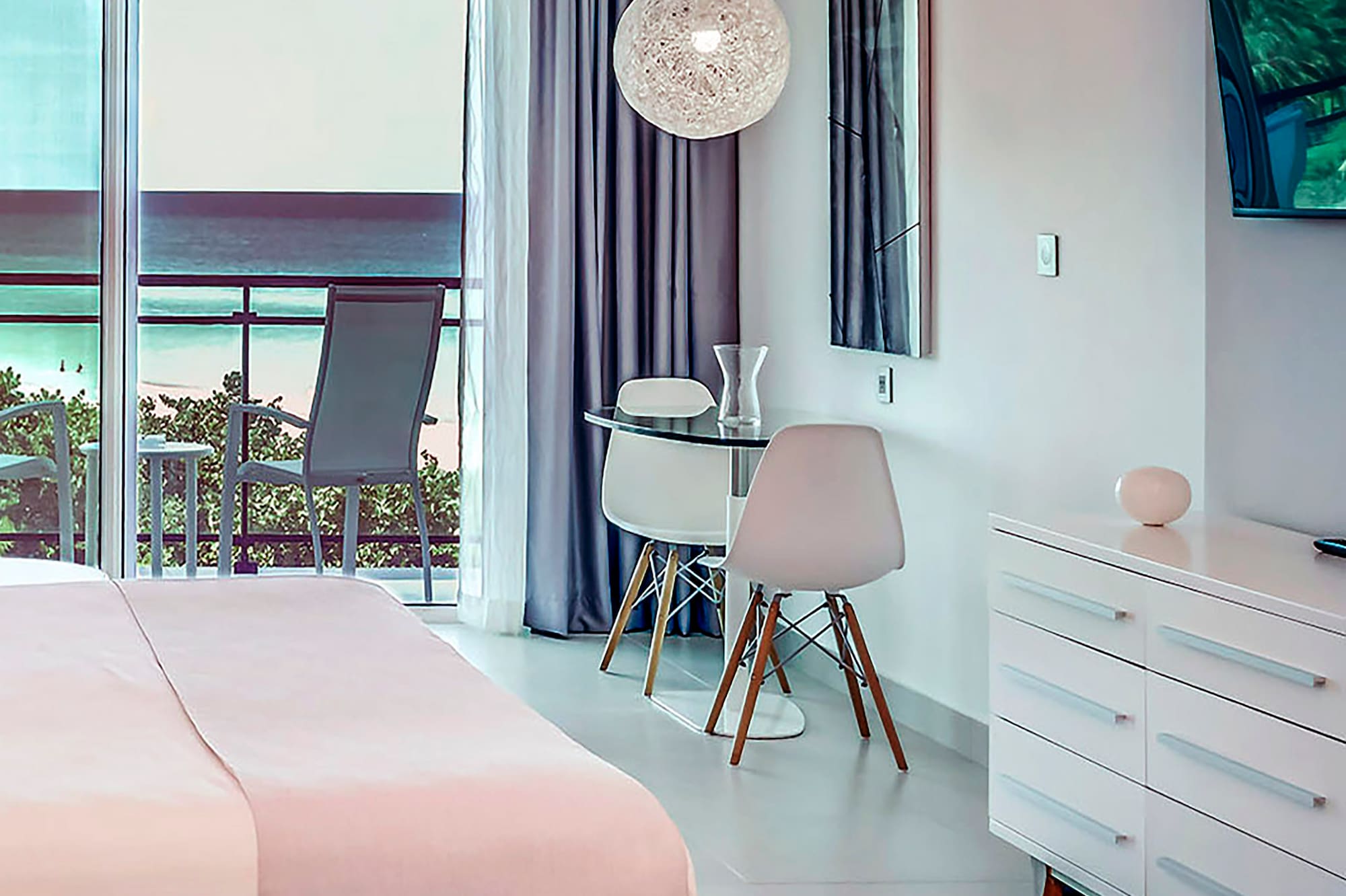 a bedroom with a bed and a desk and chairs