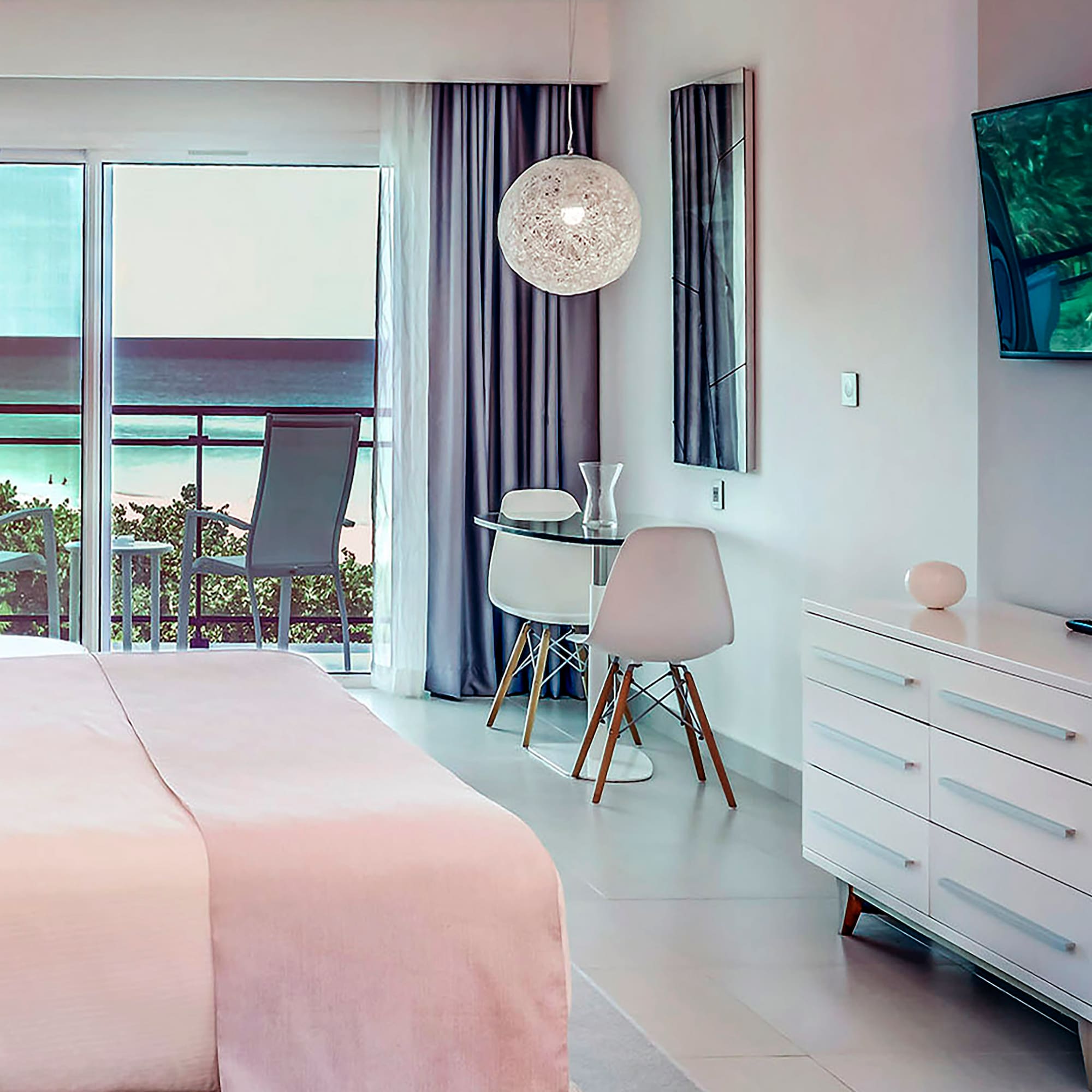 a bedroom with a bed and a desk and chairs