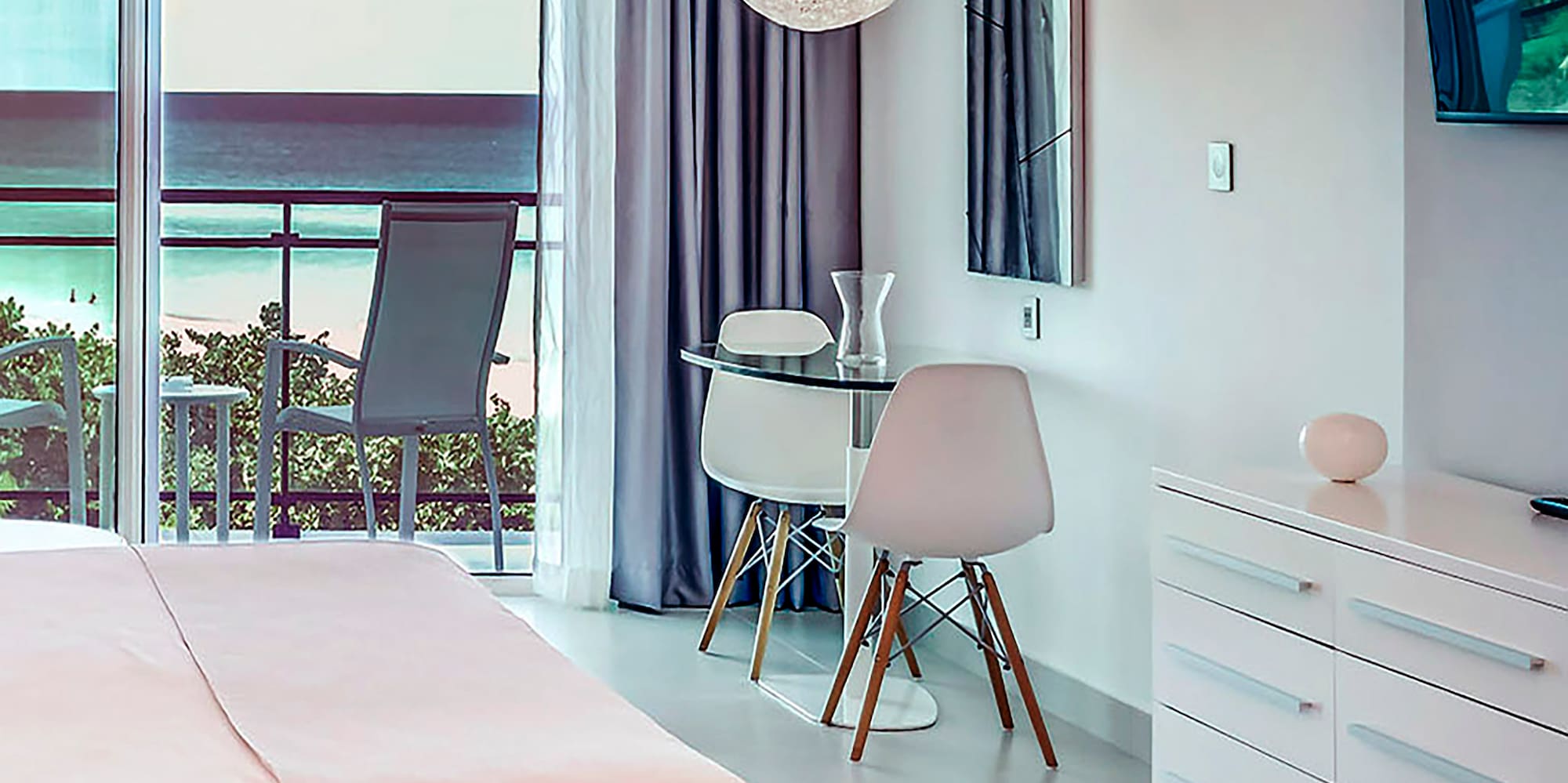 a bedroom with a bed and a desk and chairs