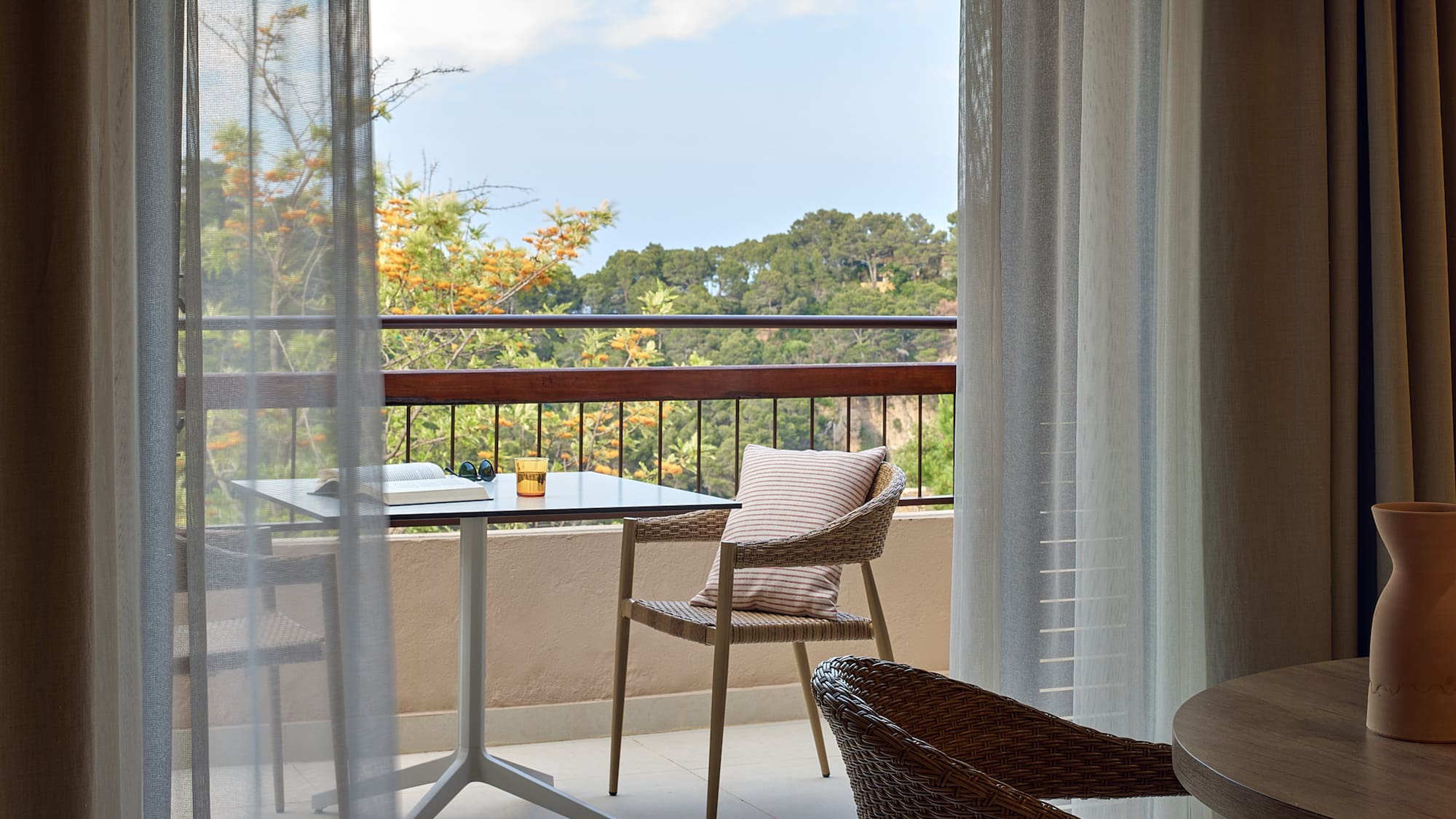 a table and chair on a balcony
