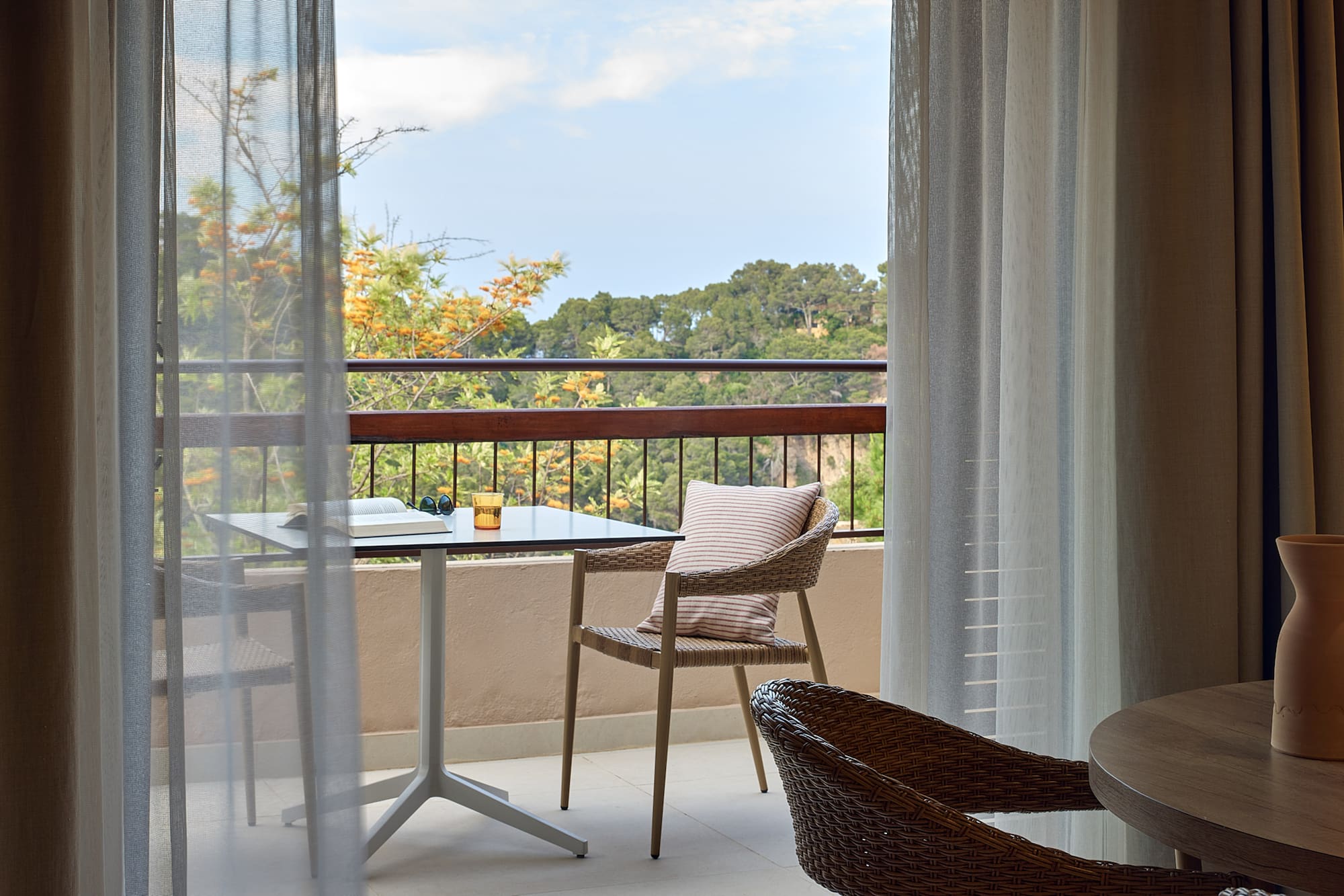 a table and chair on a balcony