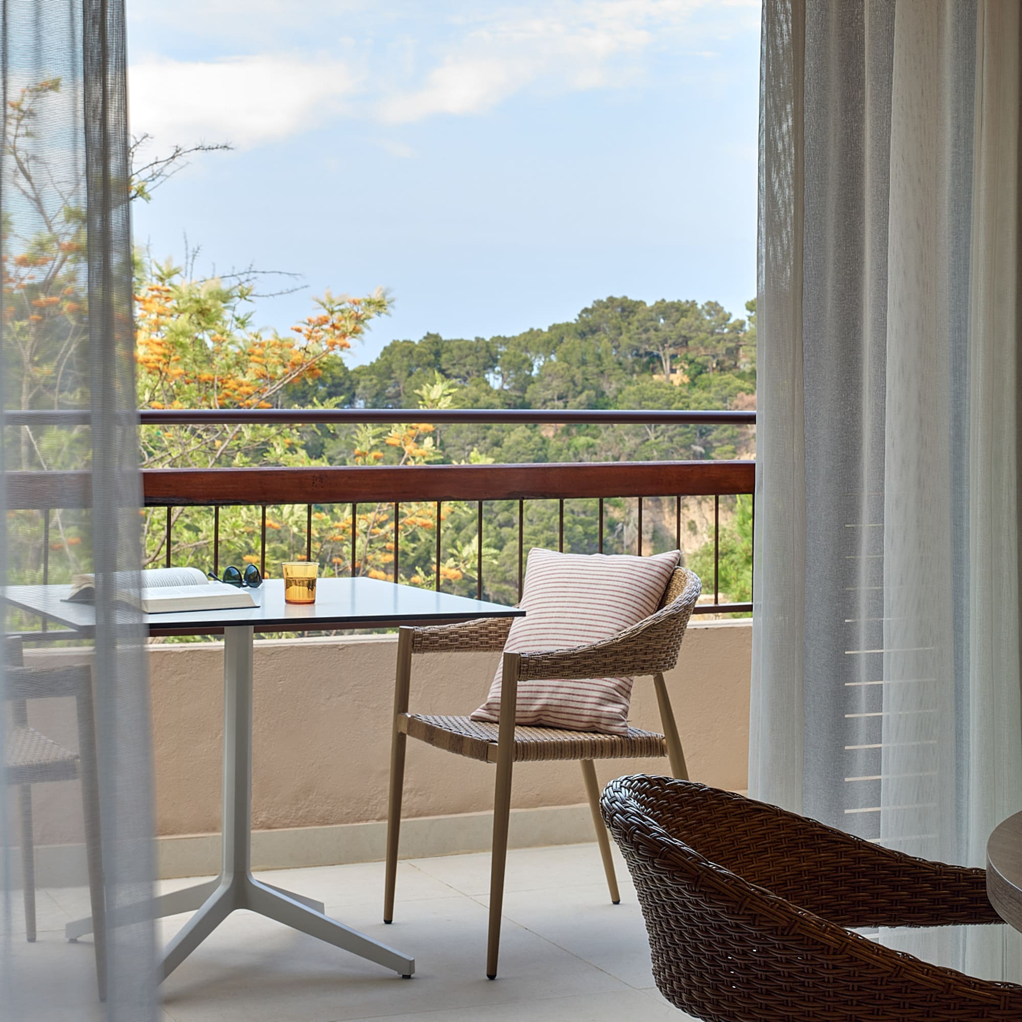 a table and chair on a balcony