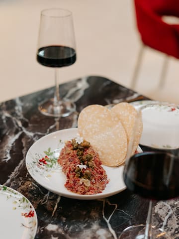 a plate of food and a glass of wine on a table
