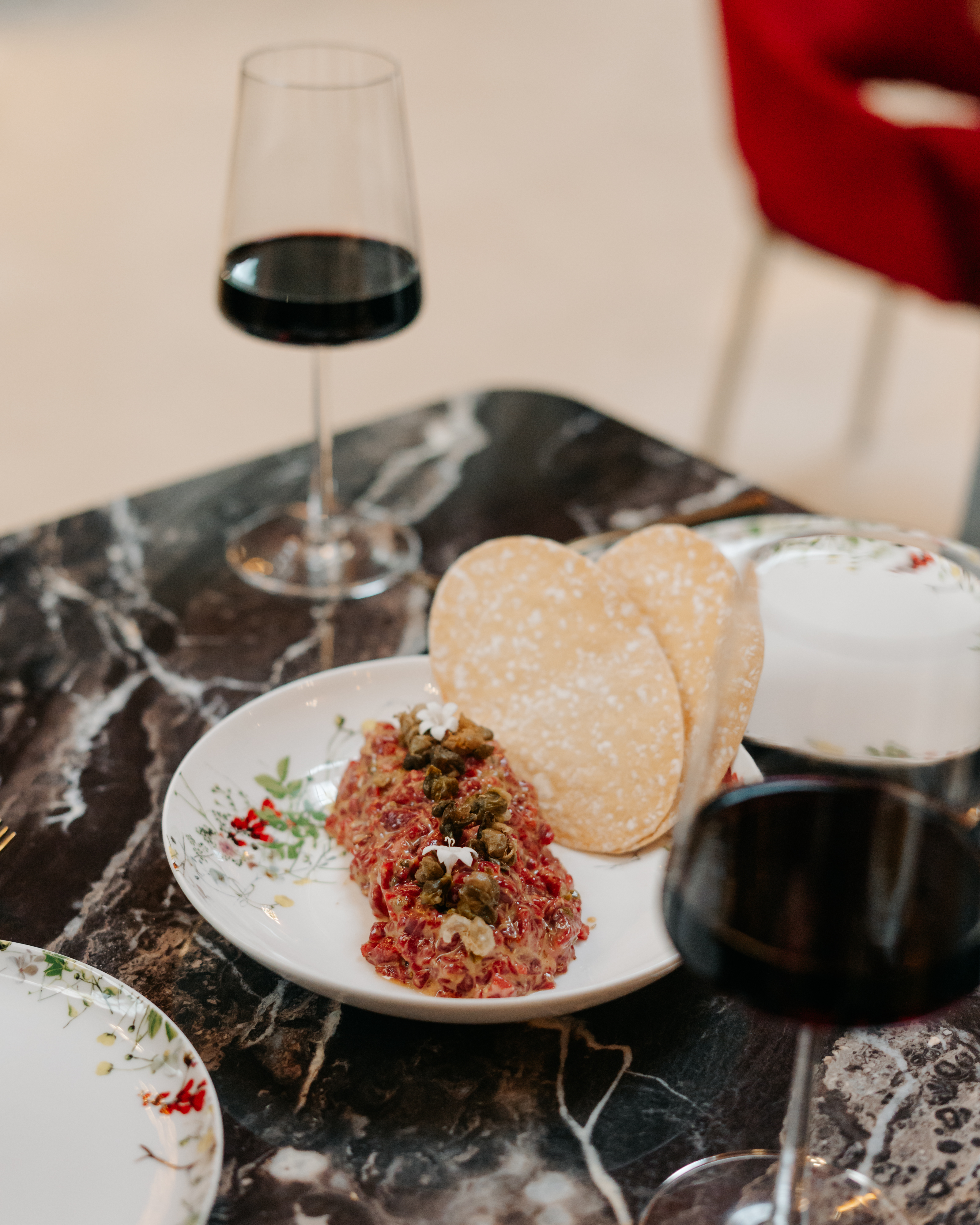 a plate of food and a glass of wine on a table