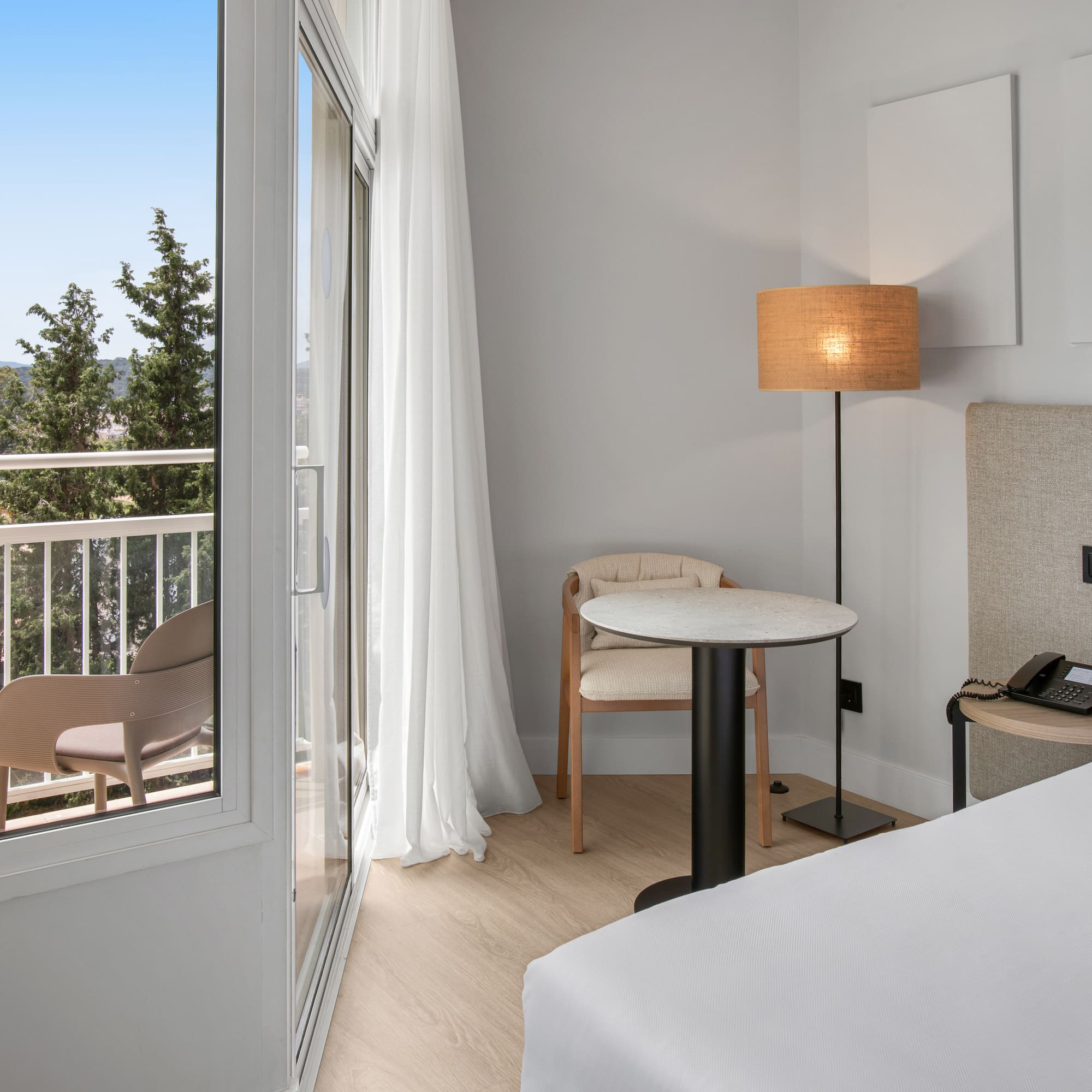 a room with a bed and a table and chairs