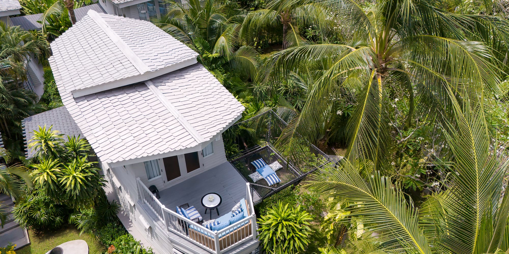 a house surrounded by palm trees
