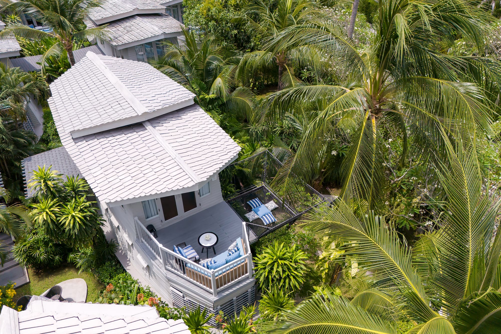 a house surrounded by palm trees
