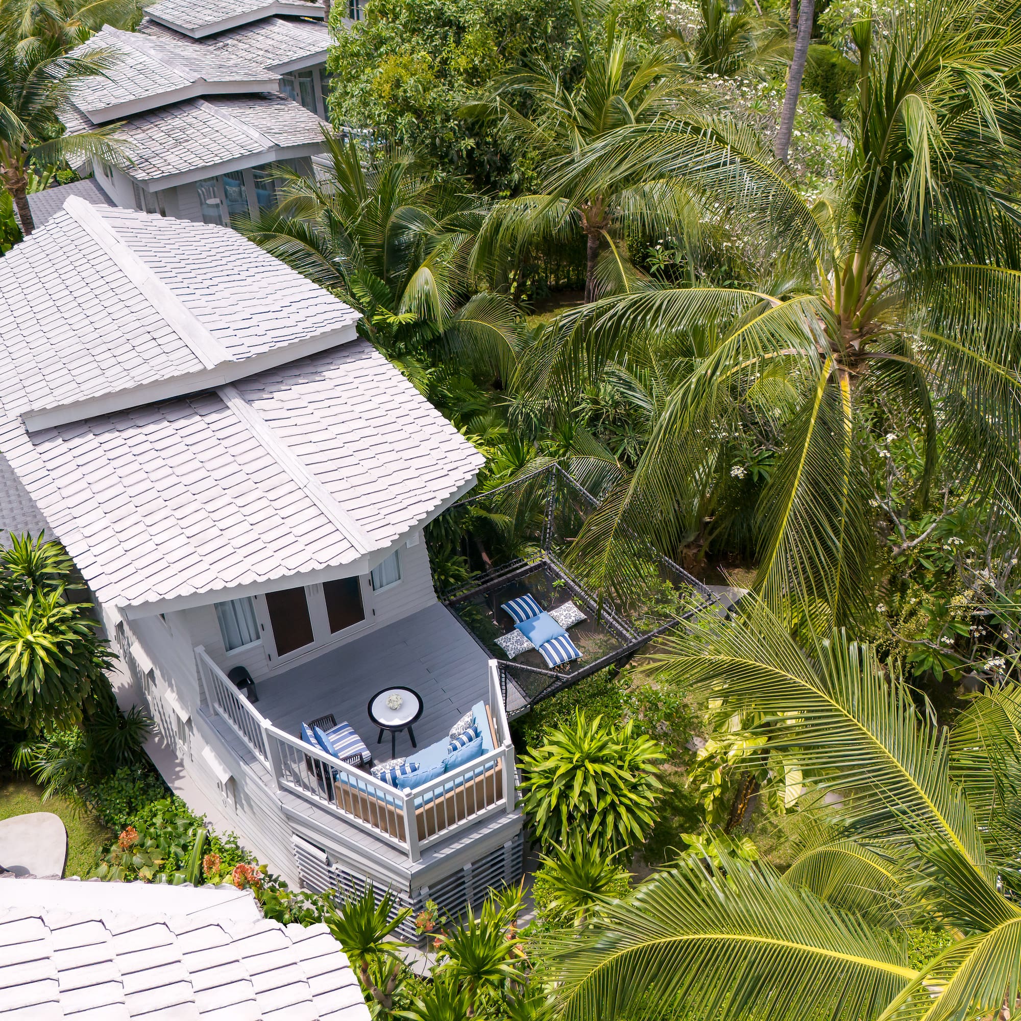 a house surrounded by palm trees