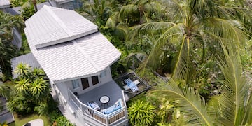 a house surrounded by palm trees