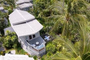 a house surrounded by palm trees