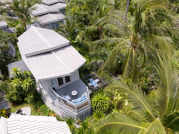 a house surrounded by palm trees