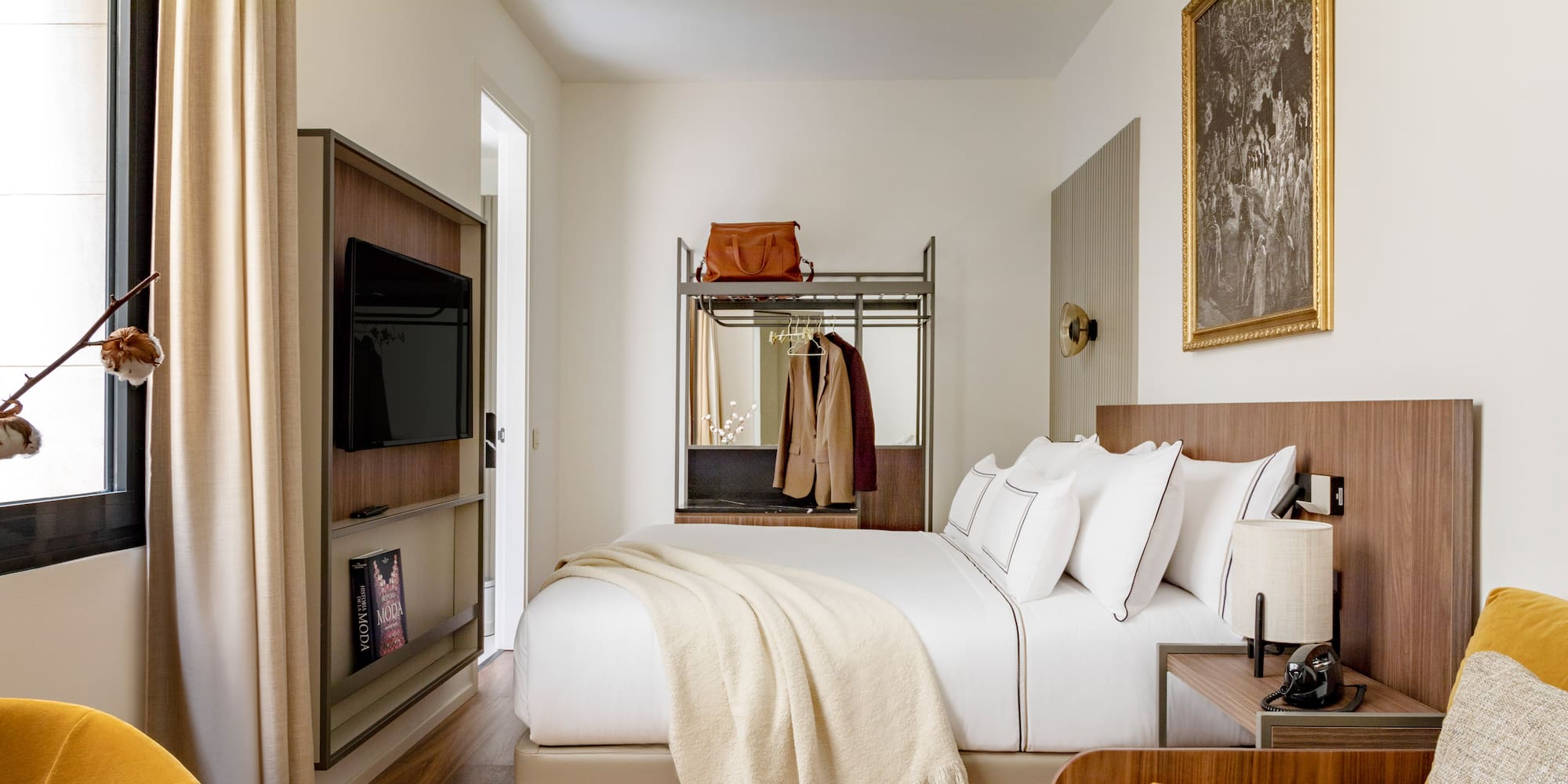 a bedroom with a bed and a tv