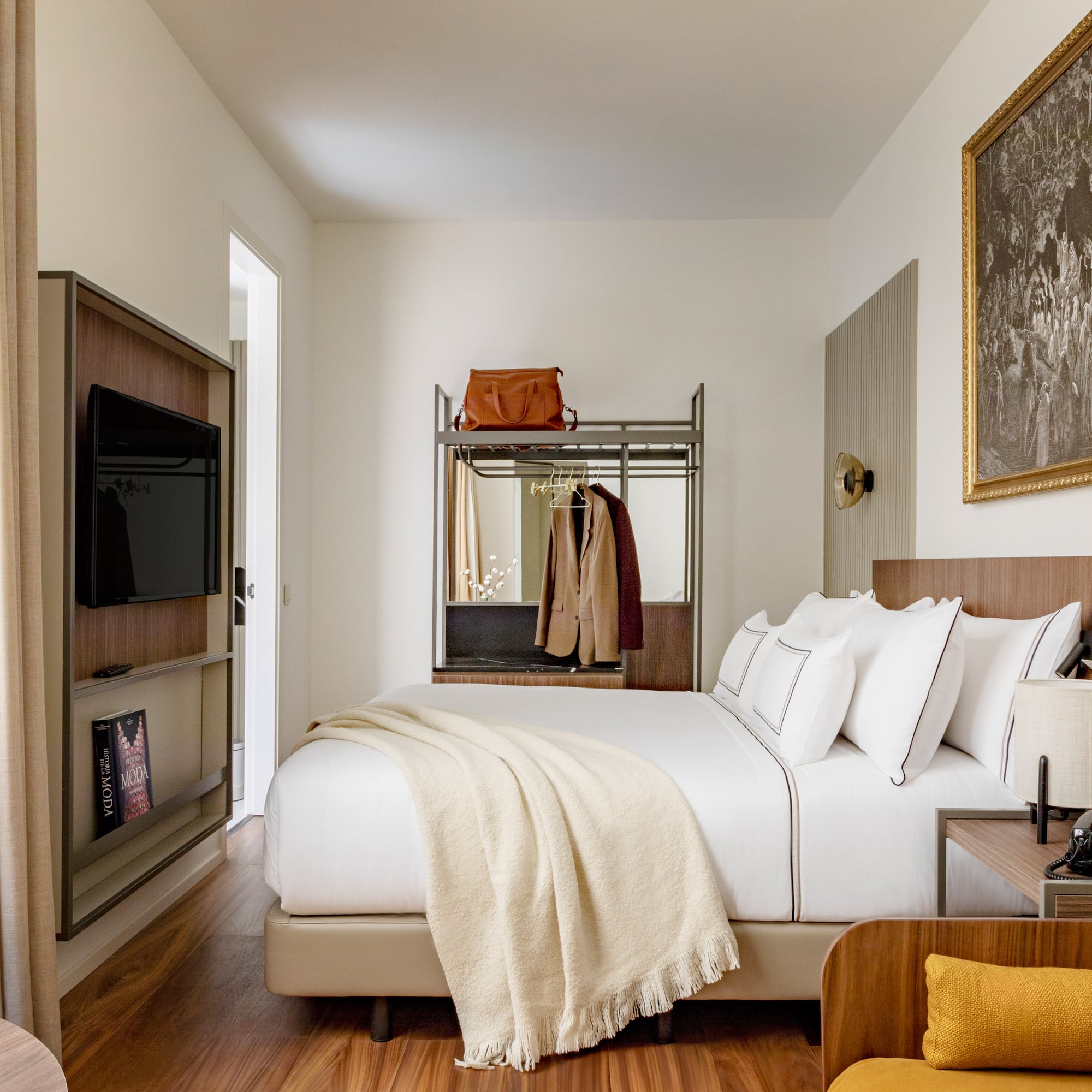 a bedroom with a bed and a tv