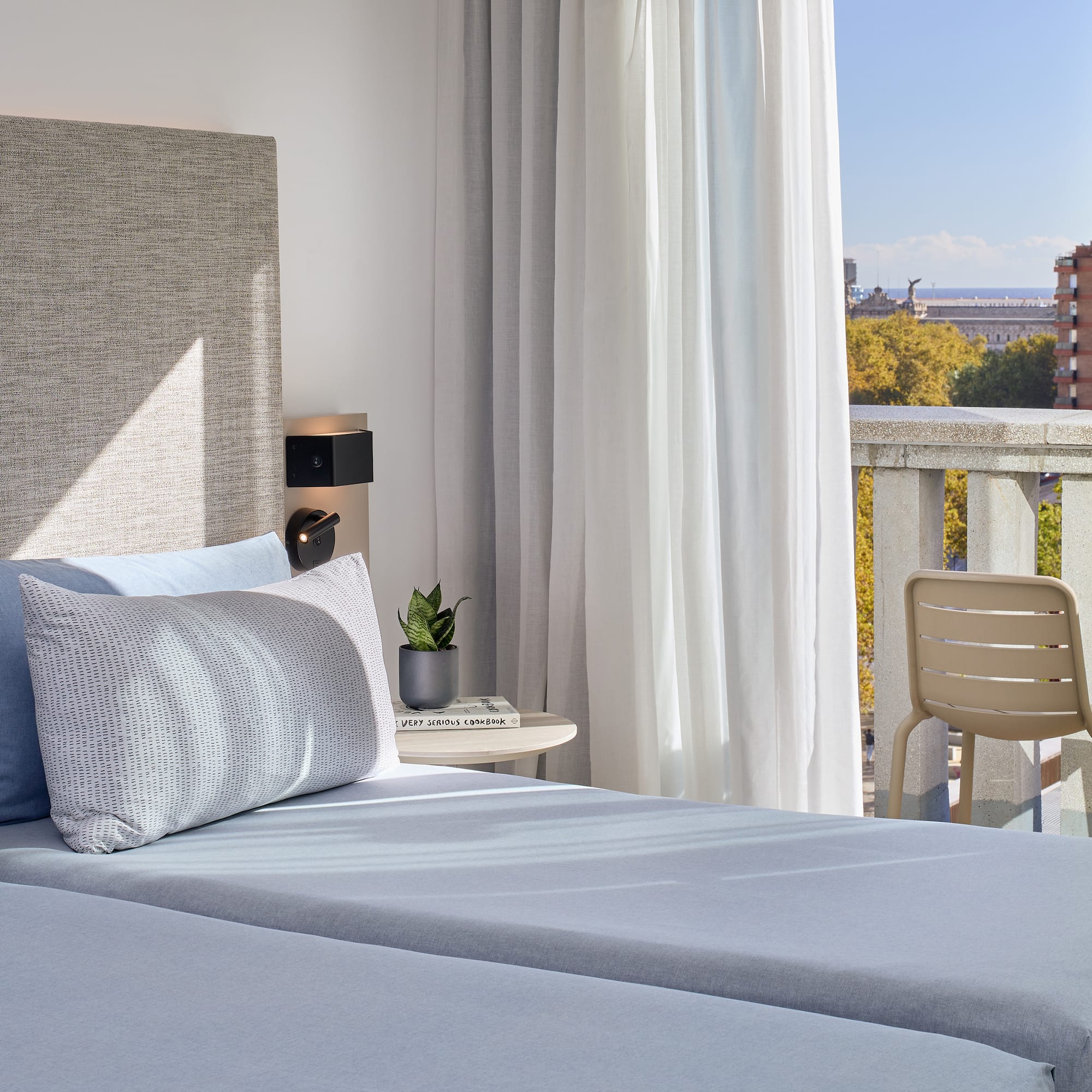 a bed with a chair and a table in front of it