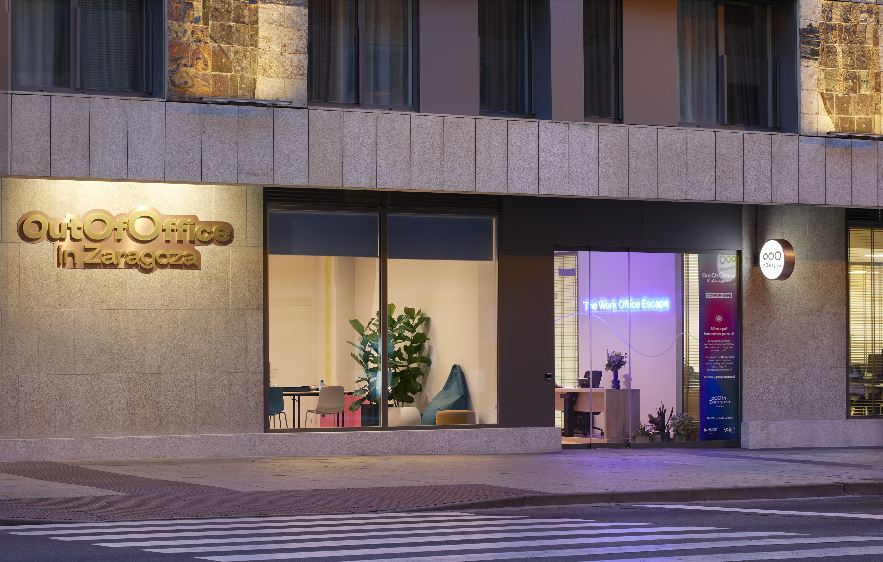 Modern OutOfOffice Zaragoza coworking space exterior at night.