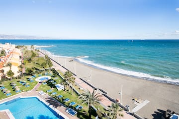 a beach with palm trees and a pool